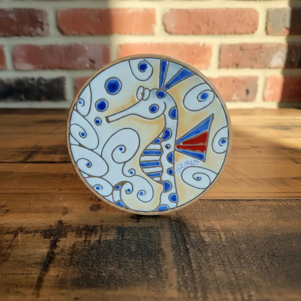 Ceramic coaster with a seahorse design
