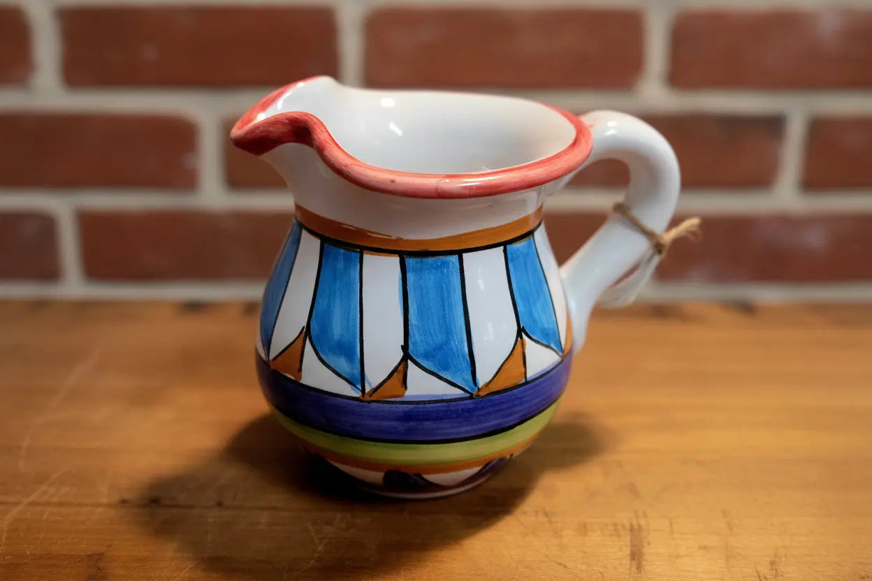 Ceramic pitcher with colorful geometric design 