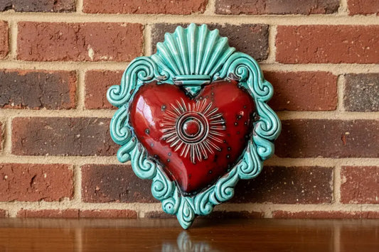Decorative wall art with a ceramic red  and turquoise heart 
