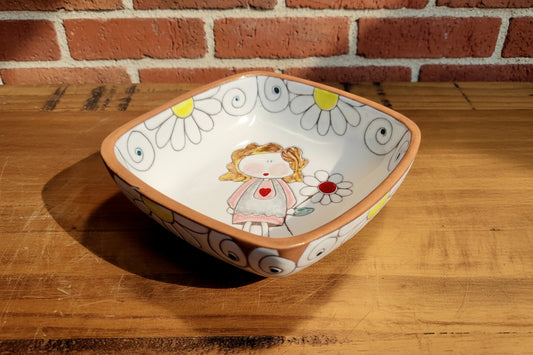 Decorative ceramic bowl with a cartoon character and floral design