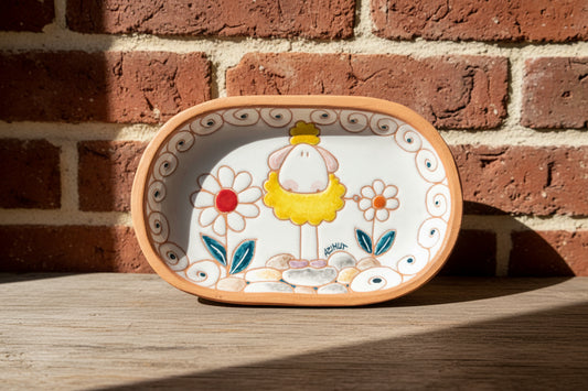 Decorative ceramic tray with a cartoon character and floral design 